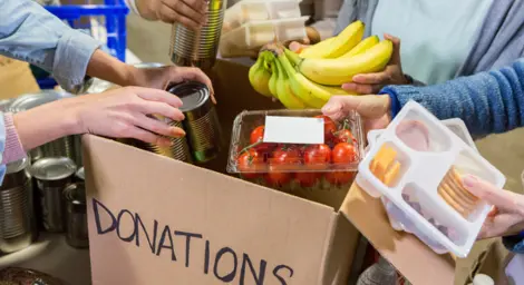 Food being placed in donations box.